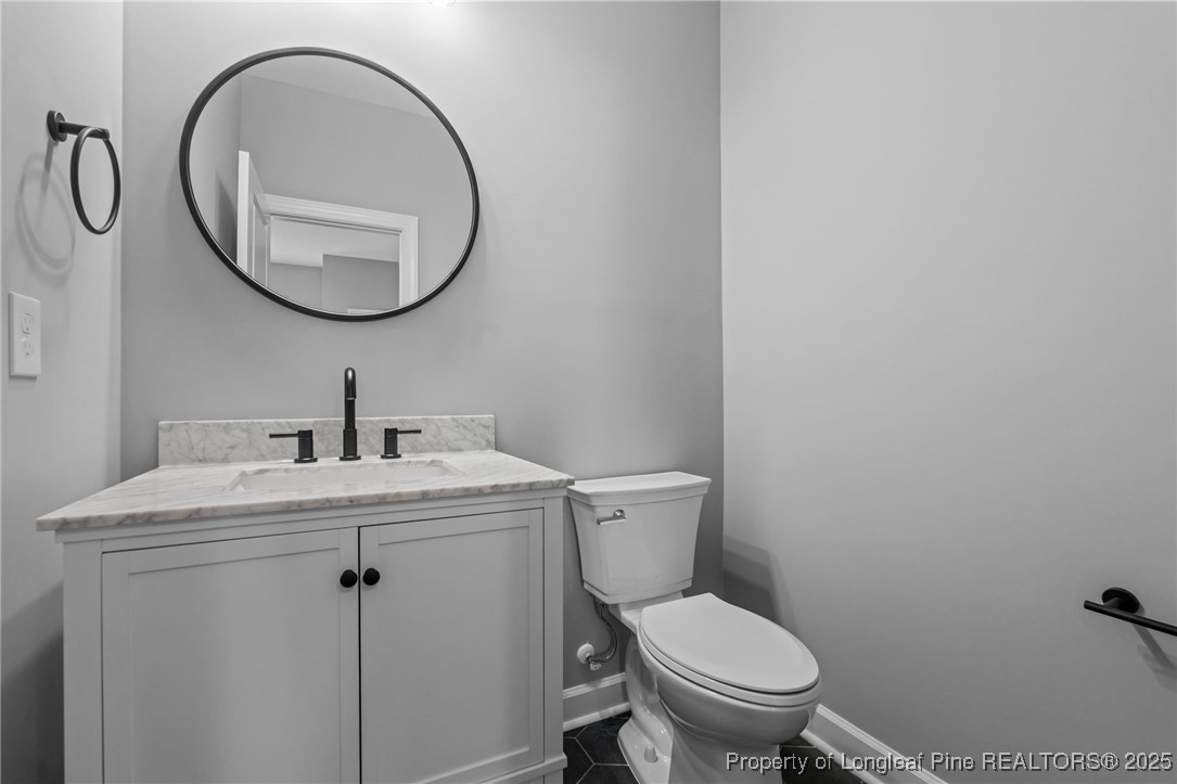 314 Persimmon Tree Drive Cameron, NC 28326 - Photo 7 of 46 a bathroom with a toilet a sink and a mirror