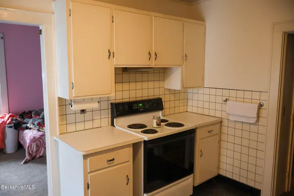 a kitchen with cabinets and appliances