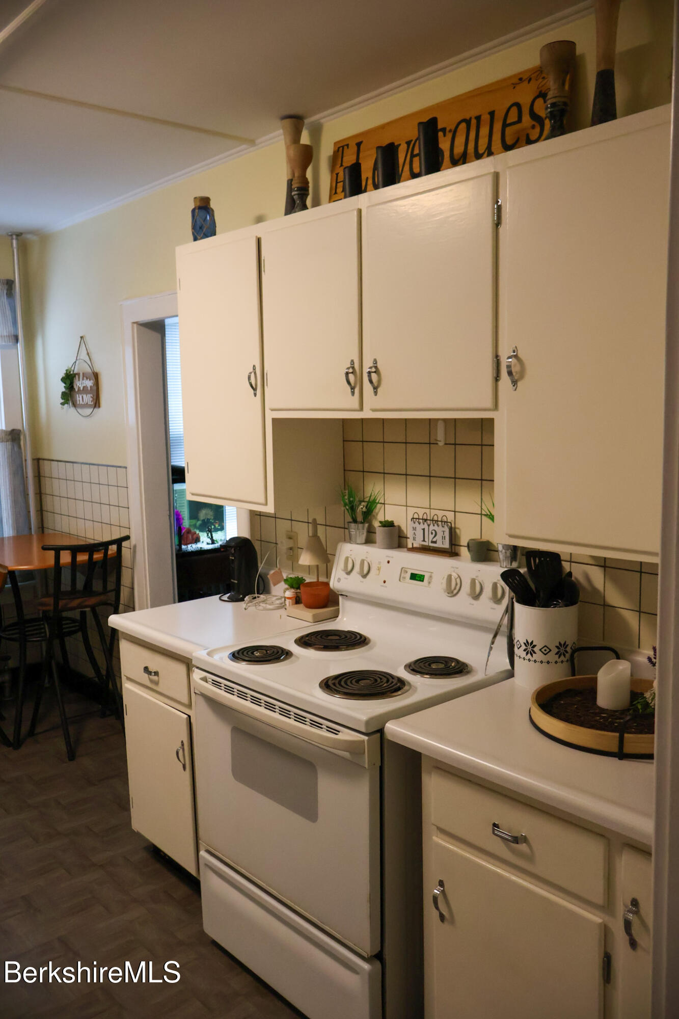 105 Friend Street Adams, MA 01220 - Photo 13 of 27 a kitchen with a sink a stove and white cabinets