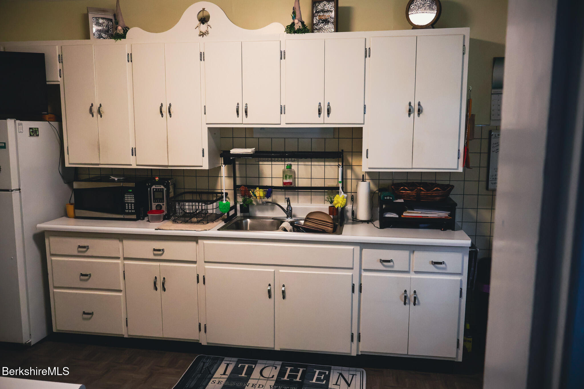 105 Friend Street Adams, MA 01220 - Photo 14 of 27 a kitchen with stainless steel appliances granite countertop a stove a sink and white cabinets