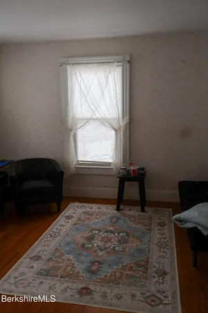 a living room with a couch and a window