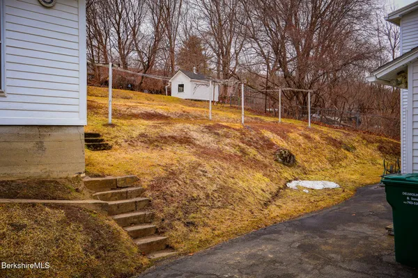 a backyard of house with large trees