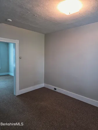 an empty room with a empty space and windows