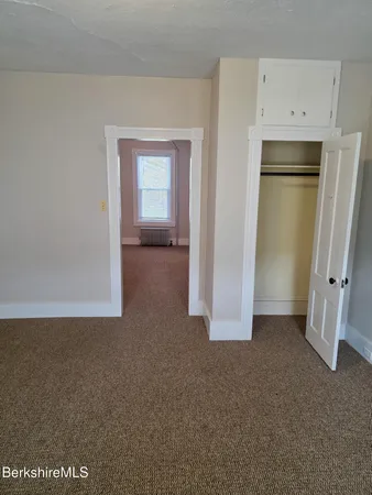 a view of a kitchen with refrigerator and cabinet