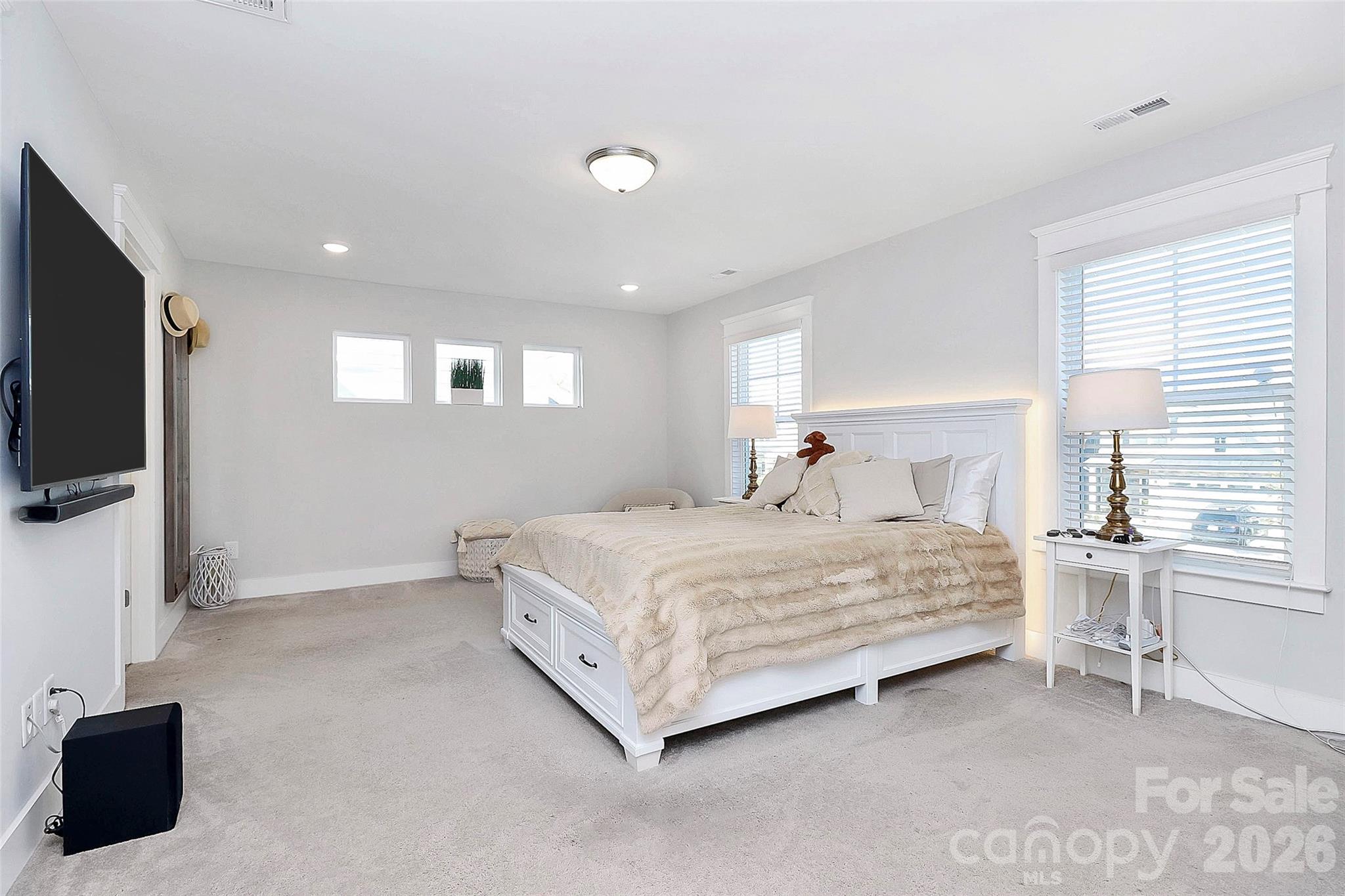 4030 Belle Landing Road, Unit 7 Charlotte, NC 28270 - Photo 12 of 24 a bedroom with a bed and a flat screen tv