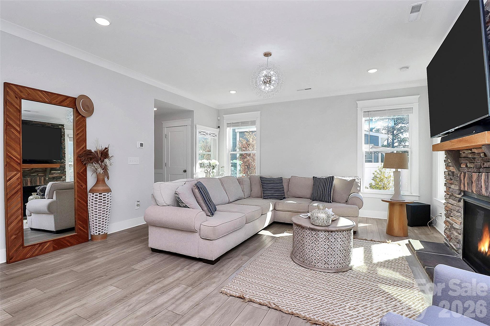 4030 Belle Landing Road, Unit 7 Charlotte, NC 28270 - Photo 8 of 24 a living room with furniture a flat screen tv and a fireplace