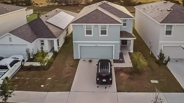 an aerial view of house with yard