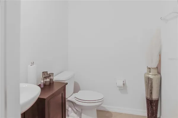 a white toilet sitting next to a bathroom sink