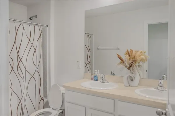 a bathroom with a sink a toilet and mirror
