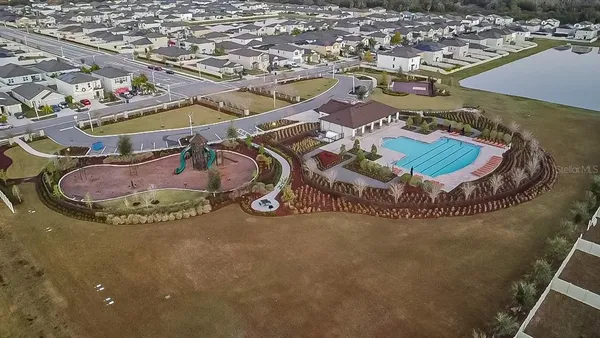 an aerial view of a house with a swimming pool