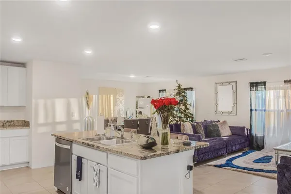 a view of kitchen island a sink and living room
