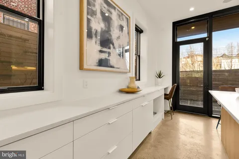 a kitchen with stainless steel appliances a sink and a large window