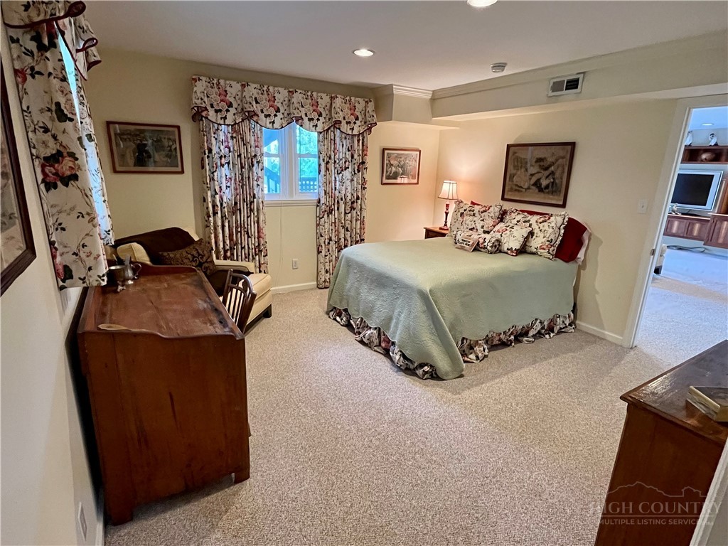638 Ridge Road Glade Valley, NC 28627 - Photo 22 of 44 a bedroom with bed and window
