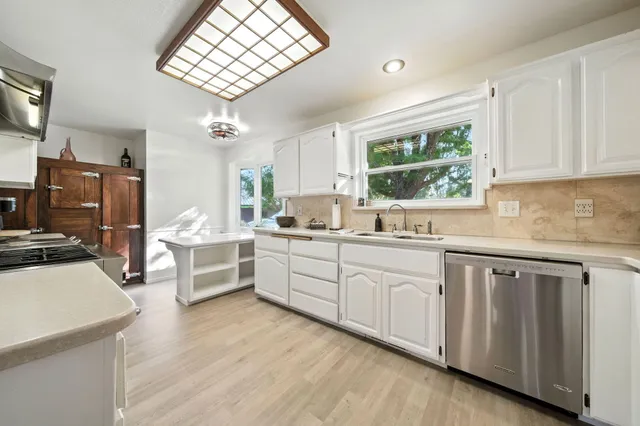 a view of a house with a backyard and a tree