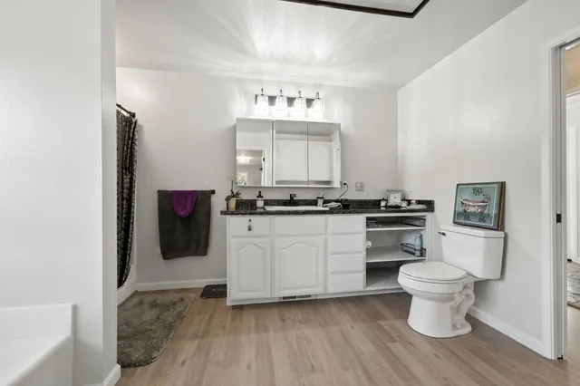 a backyard of a house with lots of green space and lake view