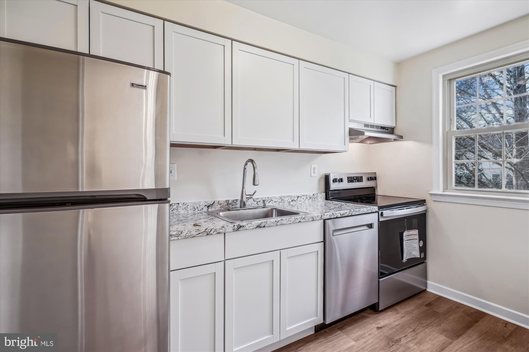 2202 Colston Drive, Unit 2202C Silver Spring, MD 20910 - Photo 11 of 42 a kitchen with a white cabinets and white appliances