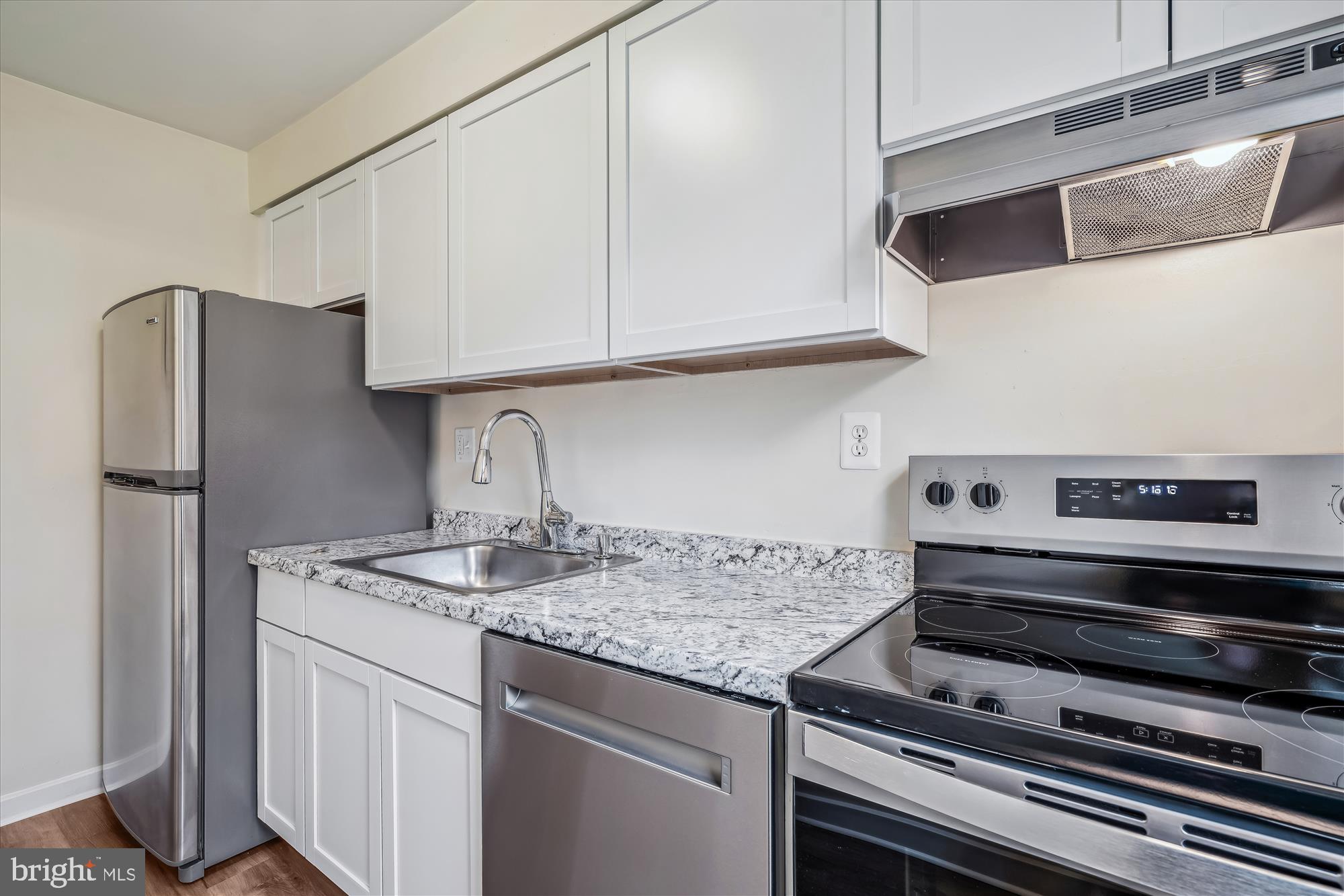 2202 Colston Drive, Unit 2202C Silver Spring, MD 20910 - Photo 12 of 42 a kitchen with stainless steel appliances granite countertop a sink stove and refrigerator