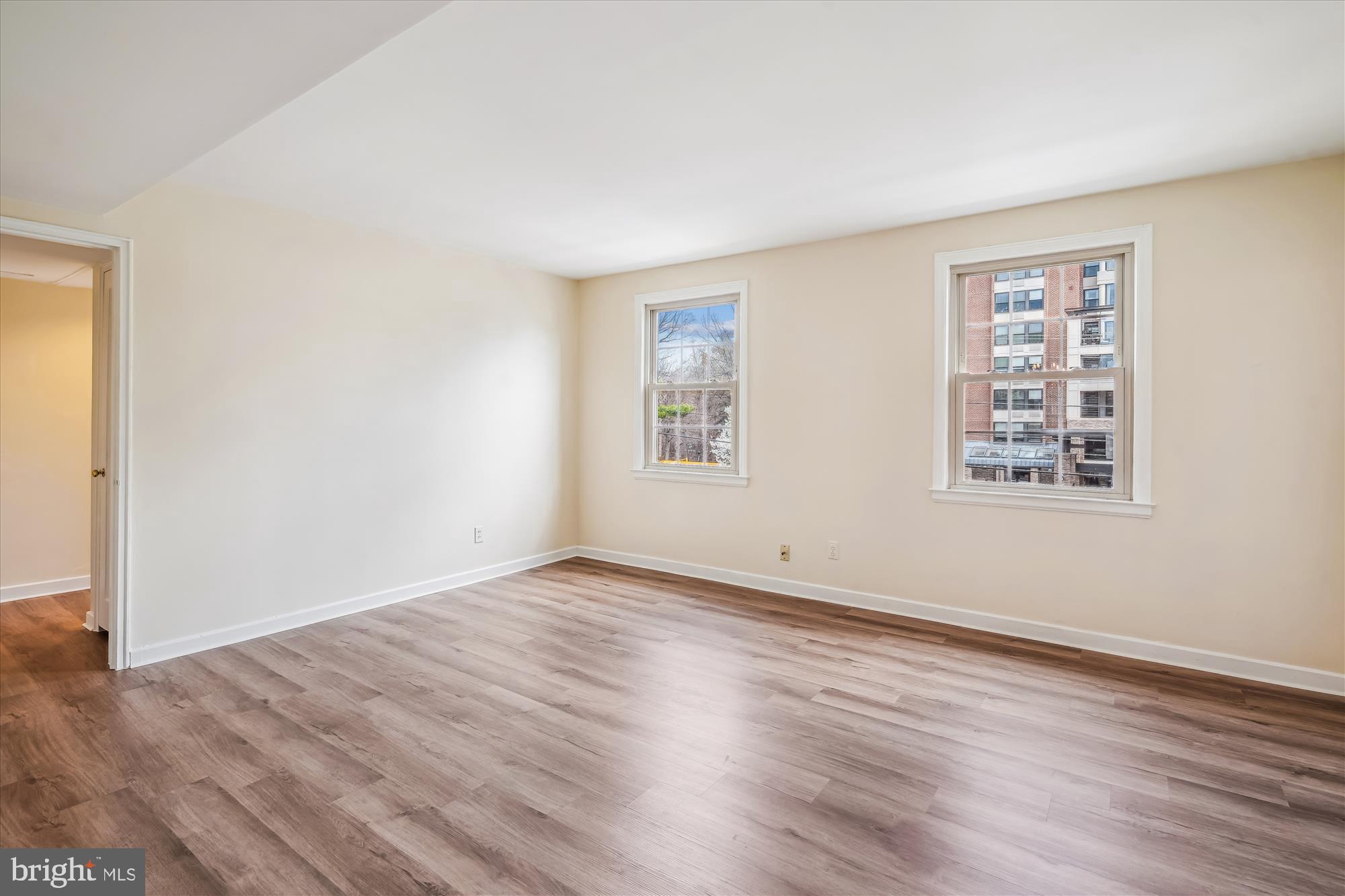 2202 Colston Drive, Unit 2202C Silver Spring, MD 20910 - Photo 13 of 42 a view of an empty room with wooden floor and a window