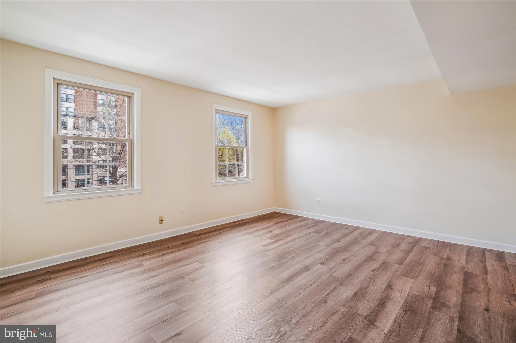 2202 Colston Drive, Unit 2202C Silver Spring, MD 20910 - Photo 15 of 42 a view of an empty room with wooden floor and a window