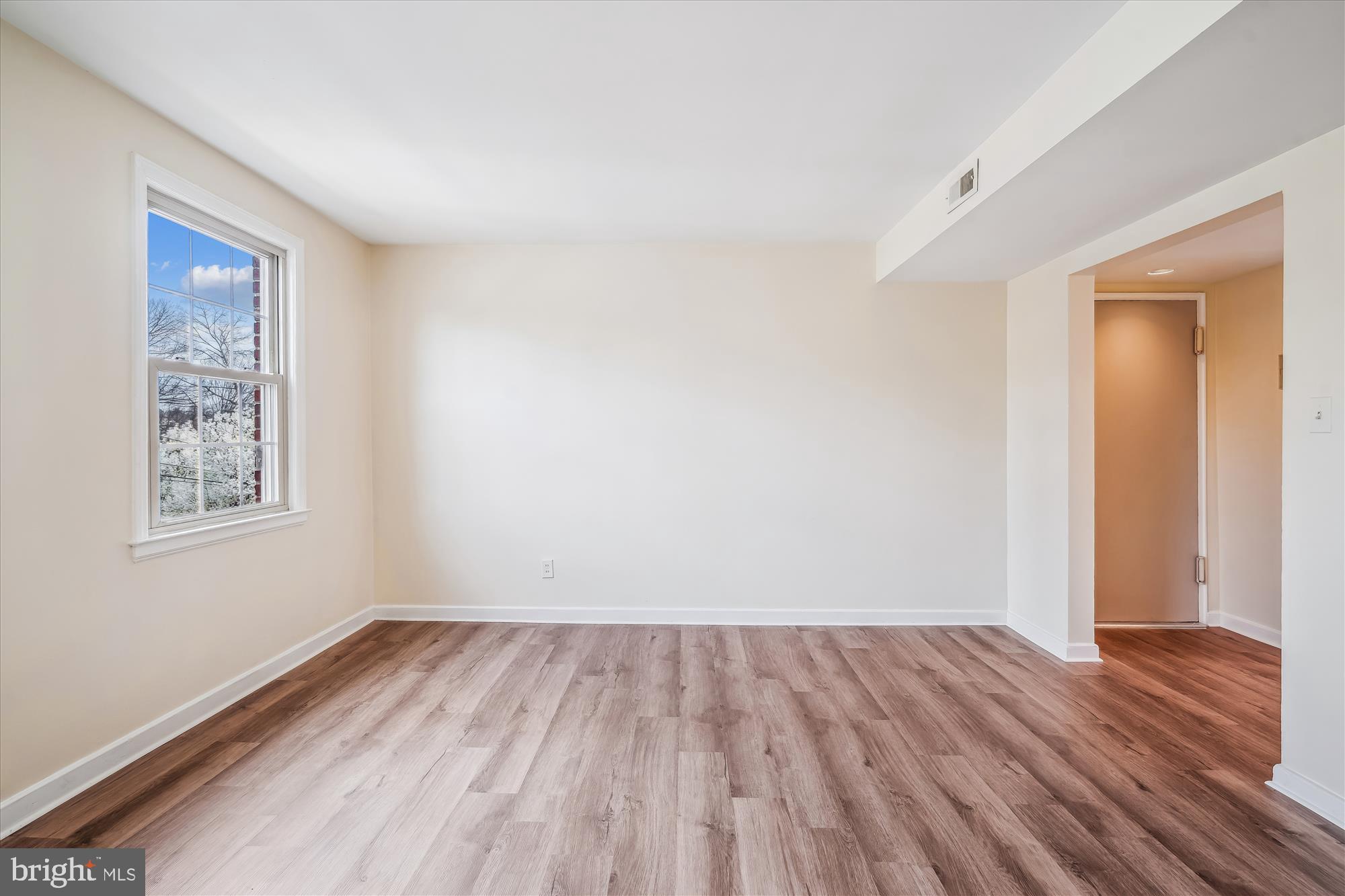 2202 Colston Drive, Unit 2202C Silver Spring, MD 20910 - Photo 16 of 42 a view of a room with wooden floor and window