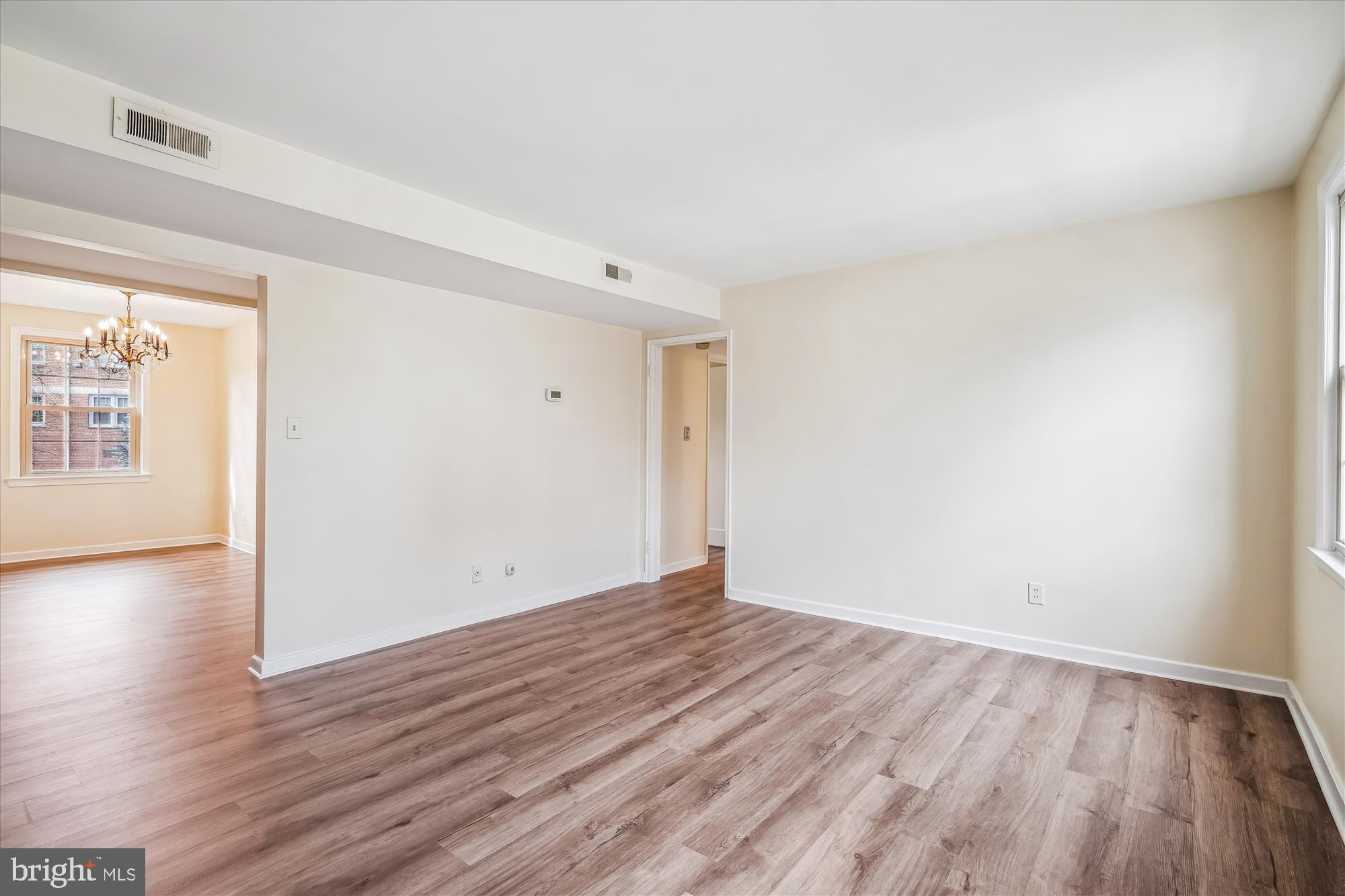 2202 Colston Drive, Unit 2202C Silver Spring, MD 20910 - Photo 17 of 42 a view of an empty room with wooden floor and a window