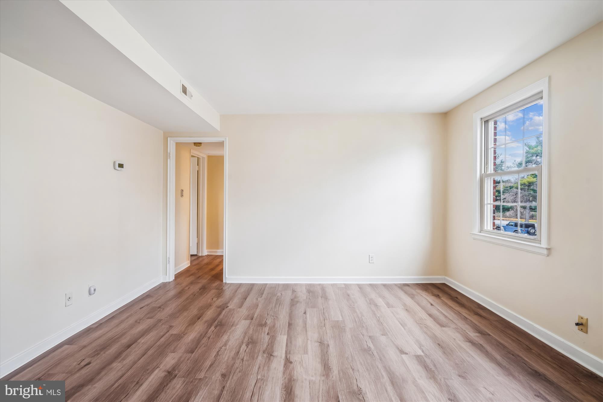 2202 Colston Drive, Unit 2202C Silver Spring, MD 20910 - Photo 18 of 42 wooden floor in an empty room with a window