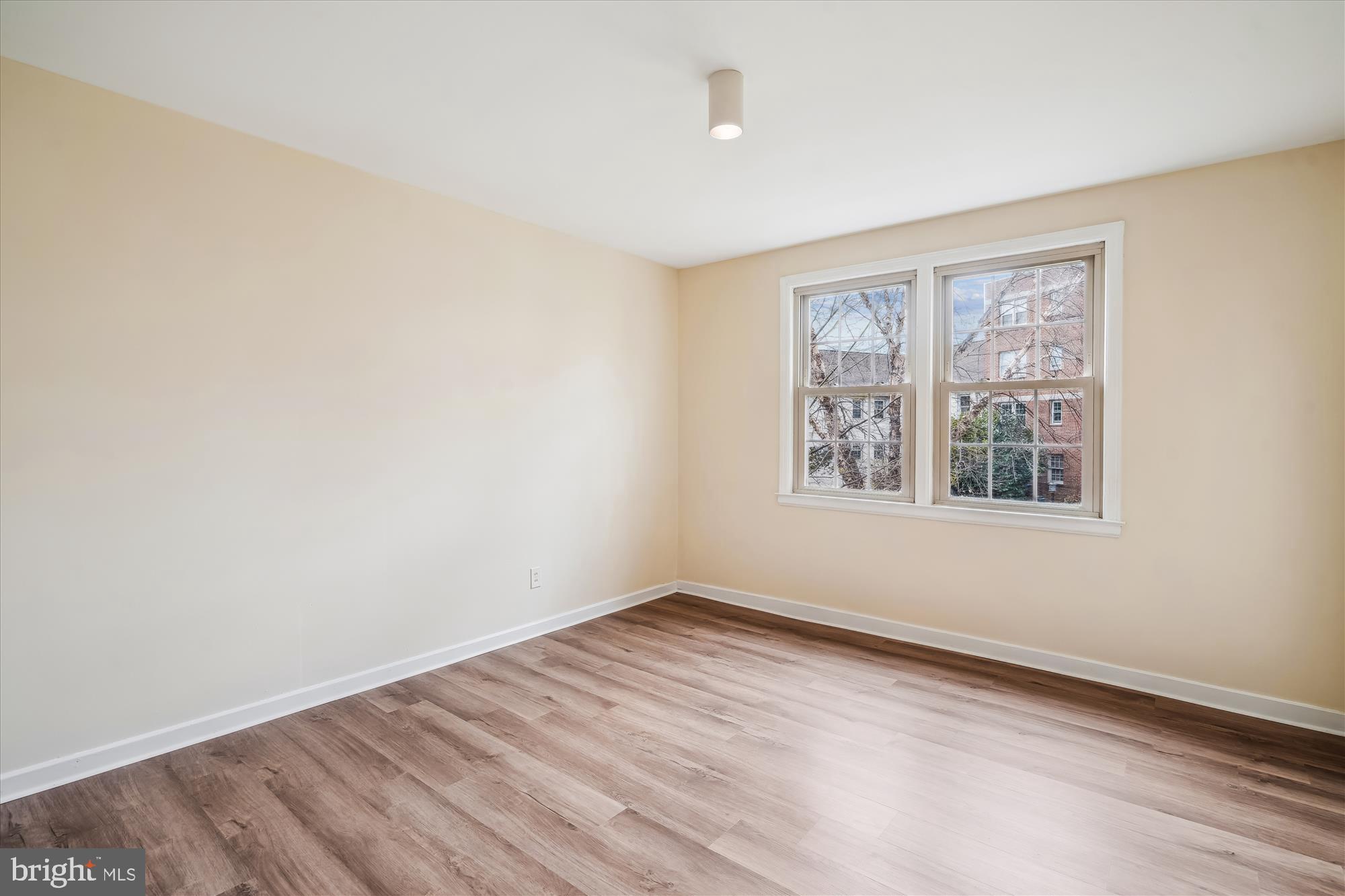 2202 Colston Drive, Unit 2202C Silver Spring, MD 20910 - Photo 19 of 42 wooden floor in an empty room with a window