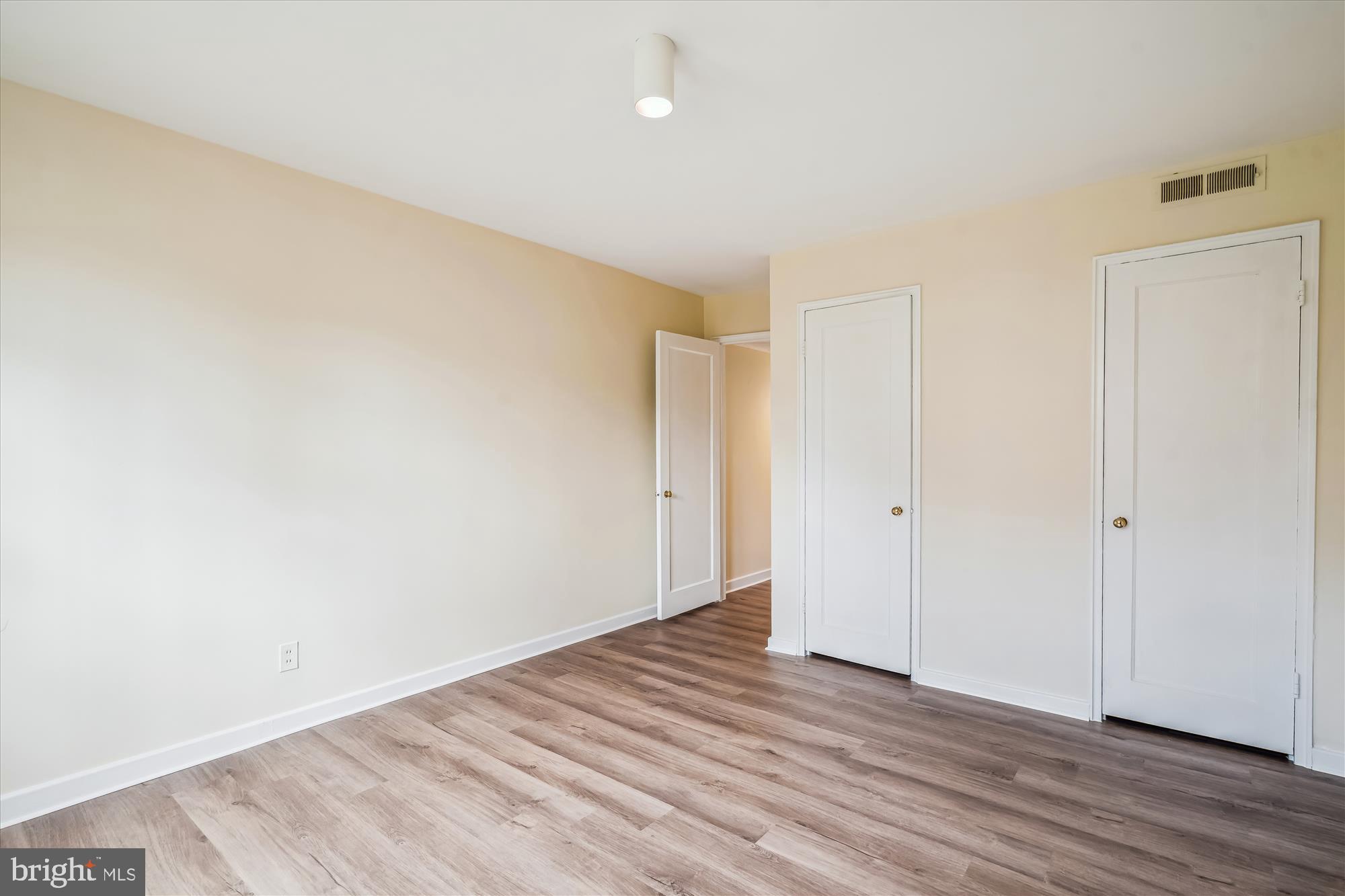 2202 Colston Drive, Unit 2202C Silver Spring, MD 20910 - Photo 20 of 42 a view of an empty room with wooden floor