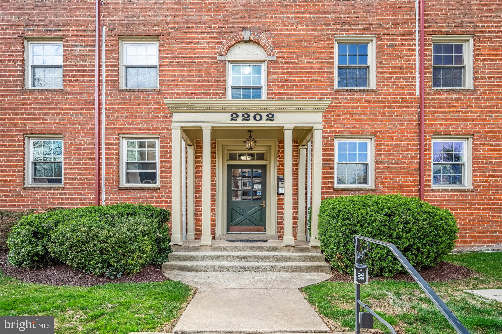 2202 Colston Drive, Unit 2202C Silver Spring, MD 20910 - Photo 6 of 42 a front view of a house with a yard and potted plants