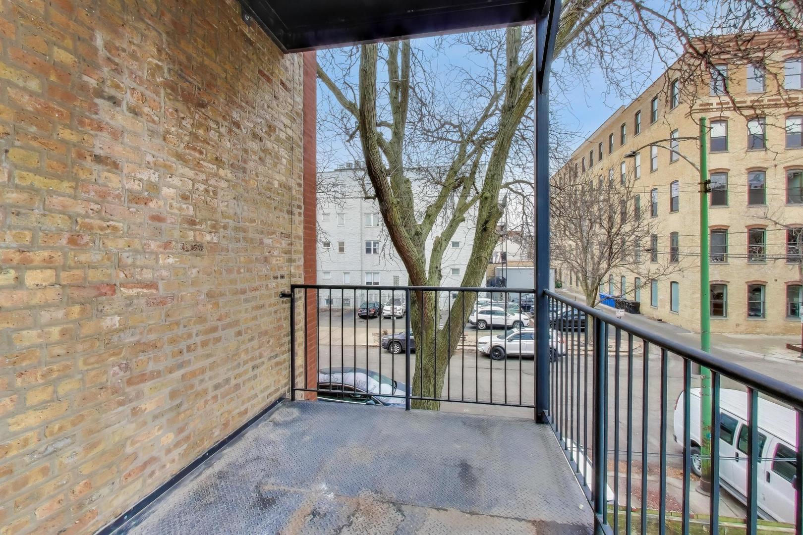 600 North May Street, Unit 2R Chicago, IL 60642 - Photo 15 of 19 a view of a porch with wooden stairs and stairs