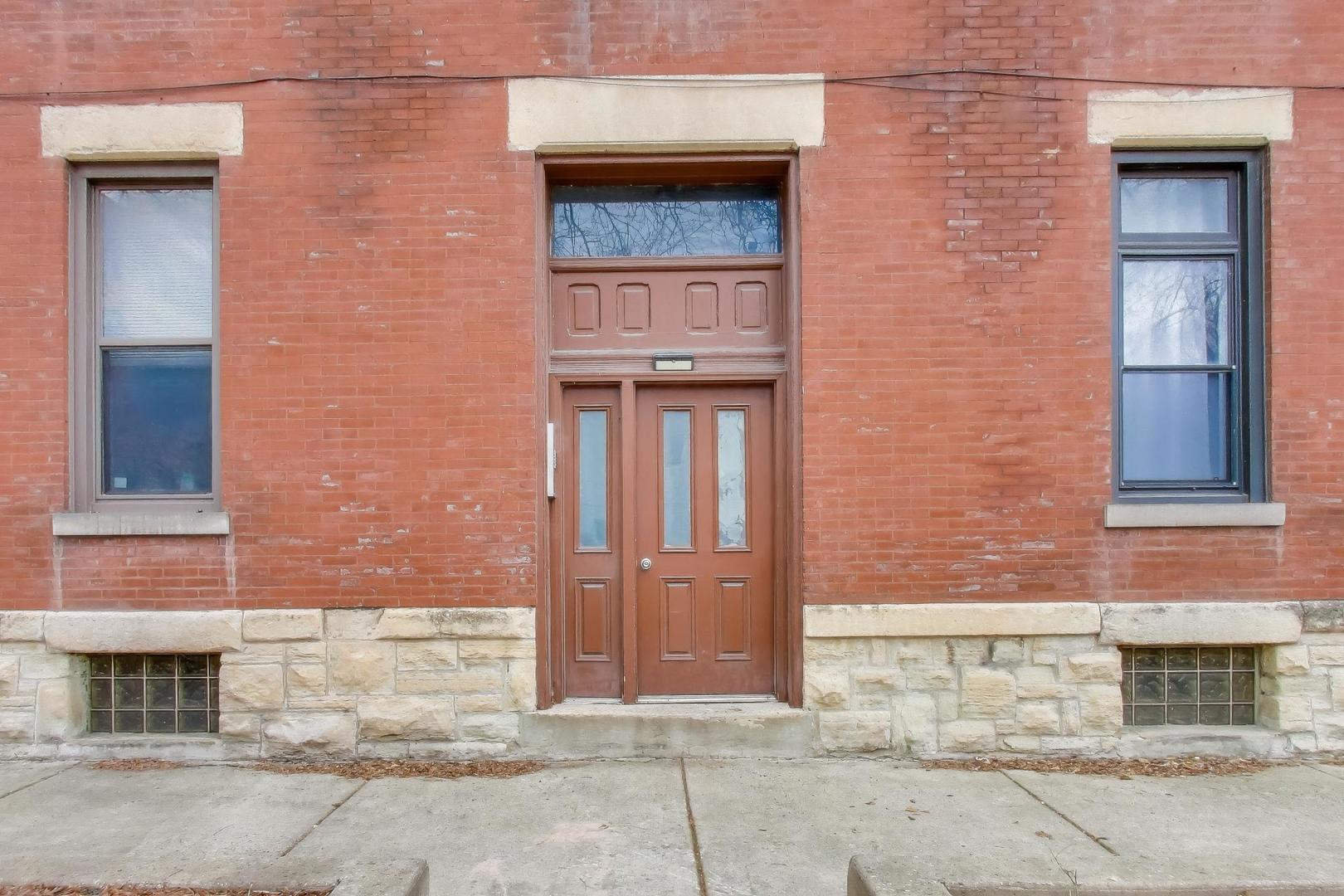 600 North May Street, Unit 2R Chicago, IL 60642 - Photo 19 of 19 front view of a brick house with a large windows
