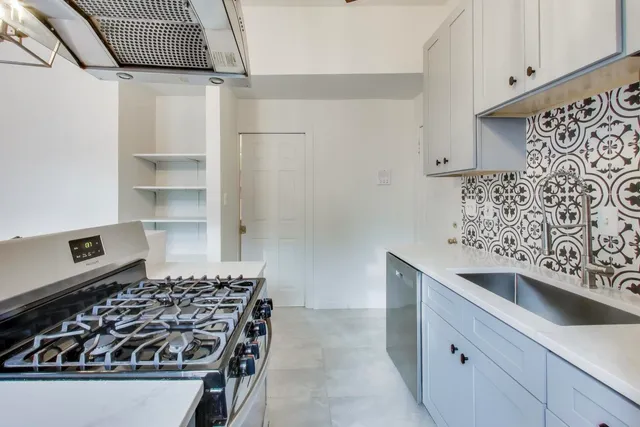 a kitchen with a stove and a refrigerator