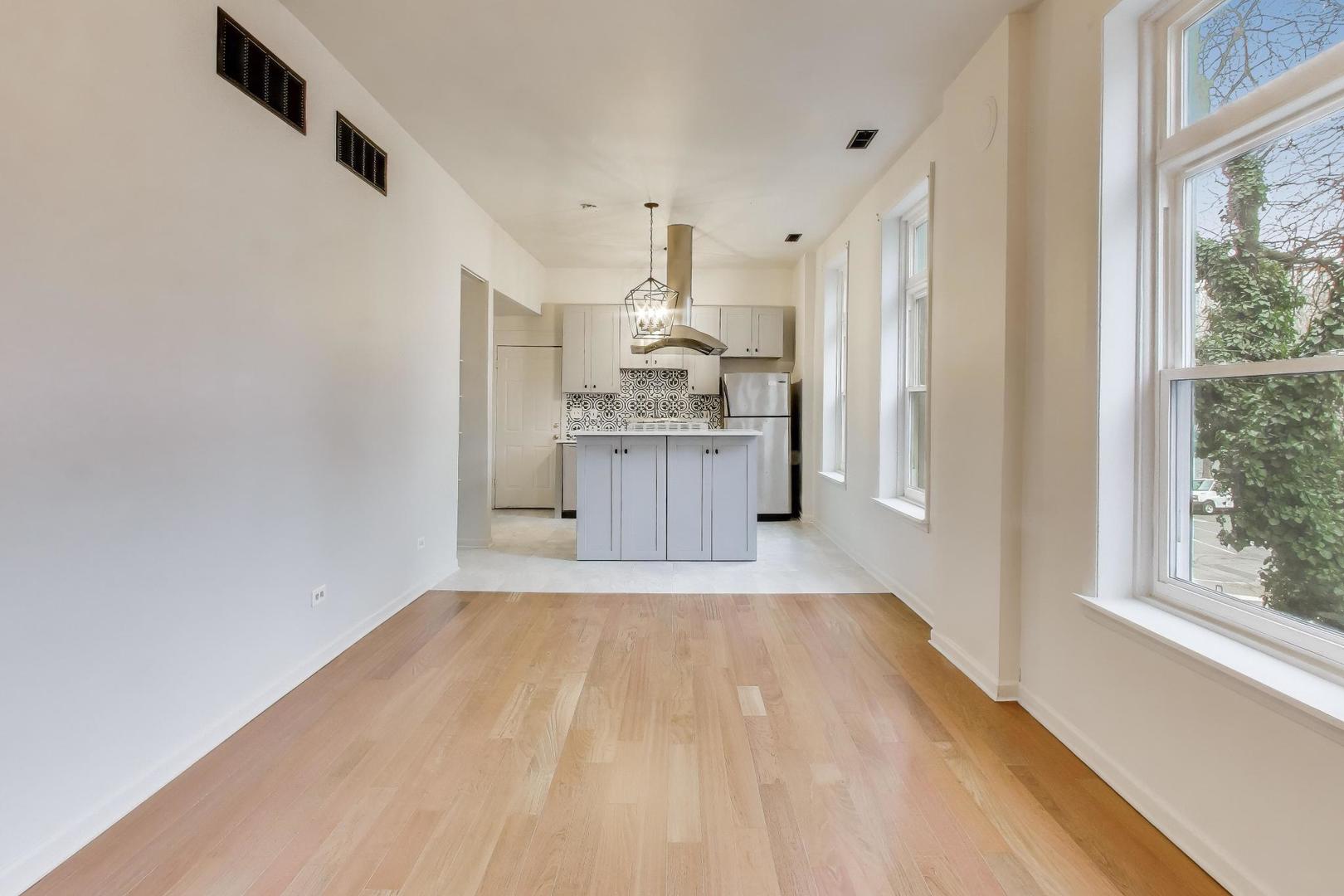 600 North May Street, Unit 2R Chicago, IL 60642 - Photo 8 of 19 a kitchen with stainless steel appliances a refrigerator and a stove top oven