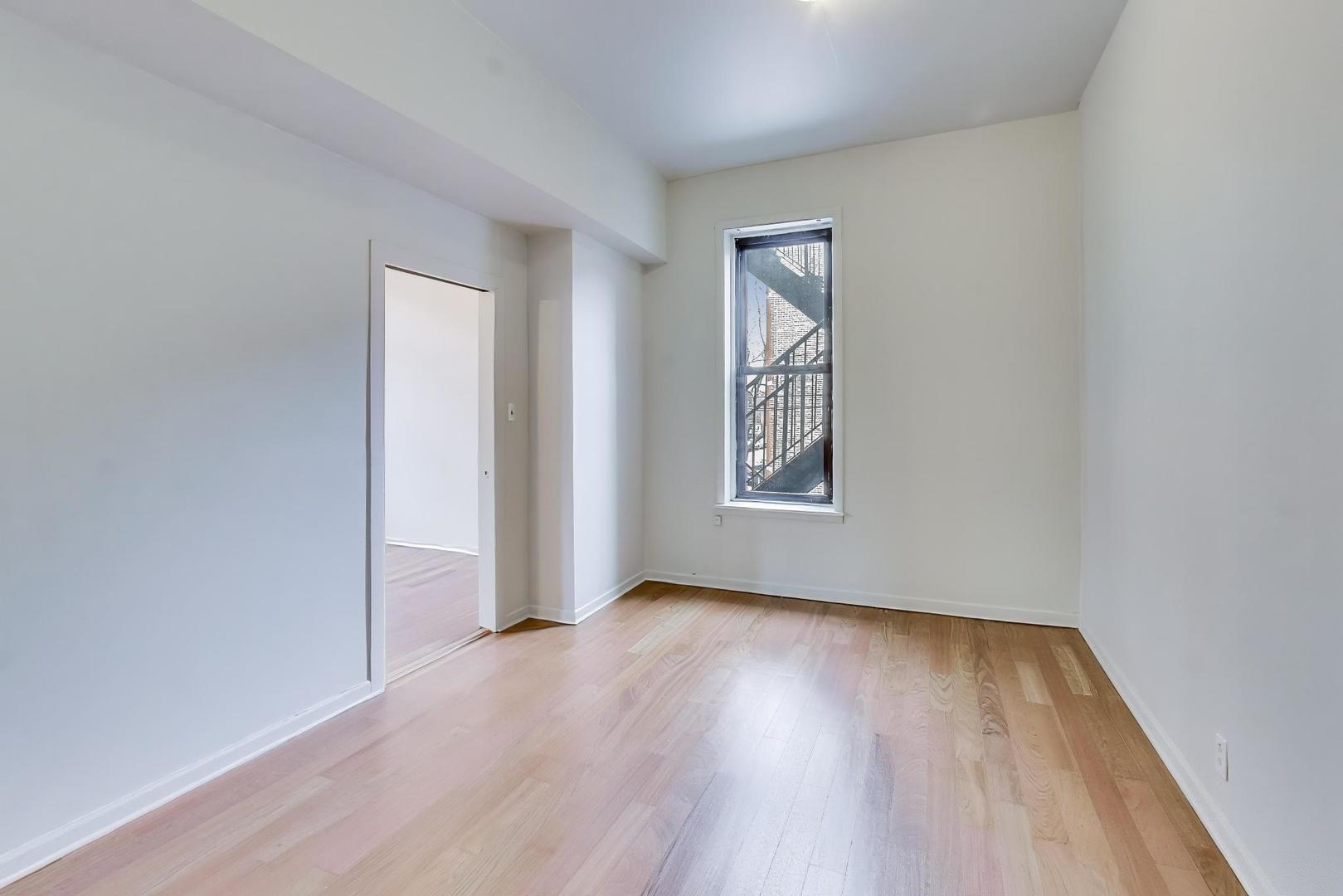 600 North May Street, Unit 2R Chicago, IL 60642 - Photo 9 of 19 an empty room with wooden floor and windows