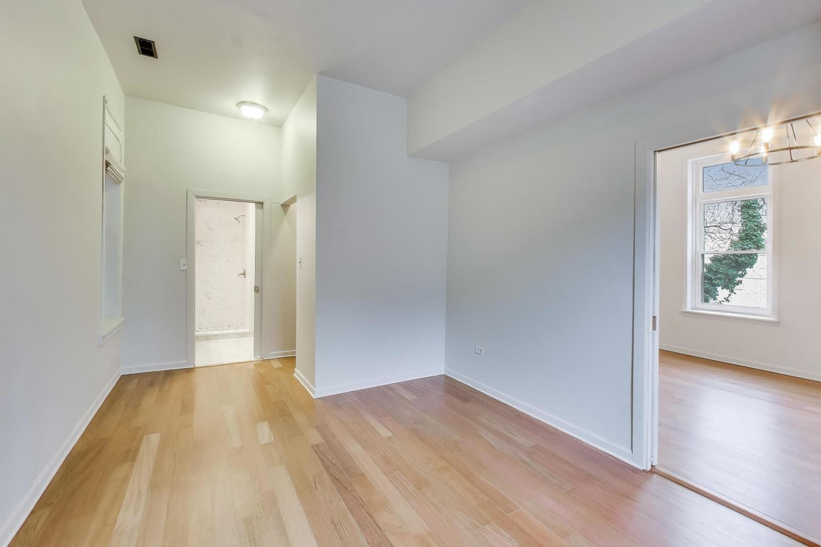 600 North May Street, Unit 2R Chicago, IL 60642 - Photo 10 of 19 wooden floor in an empty room with a window