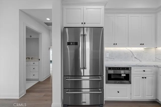 a kitchen with stainless steel appliances a refrigerator and cabinets