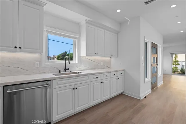 a kitchen with sink and cabinets