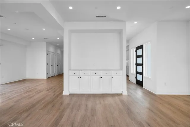 an empty room with wooden floor