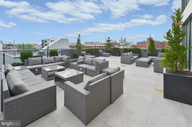 a view of a terrace with couches and potted plants