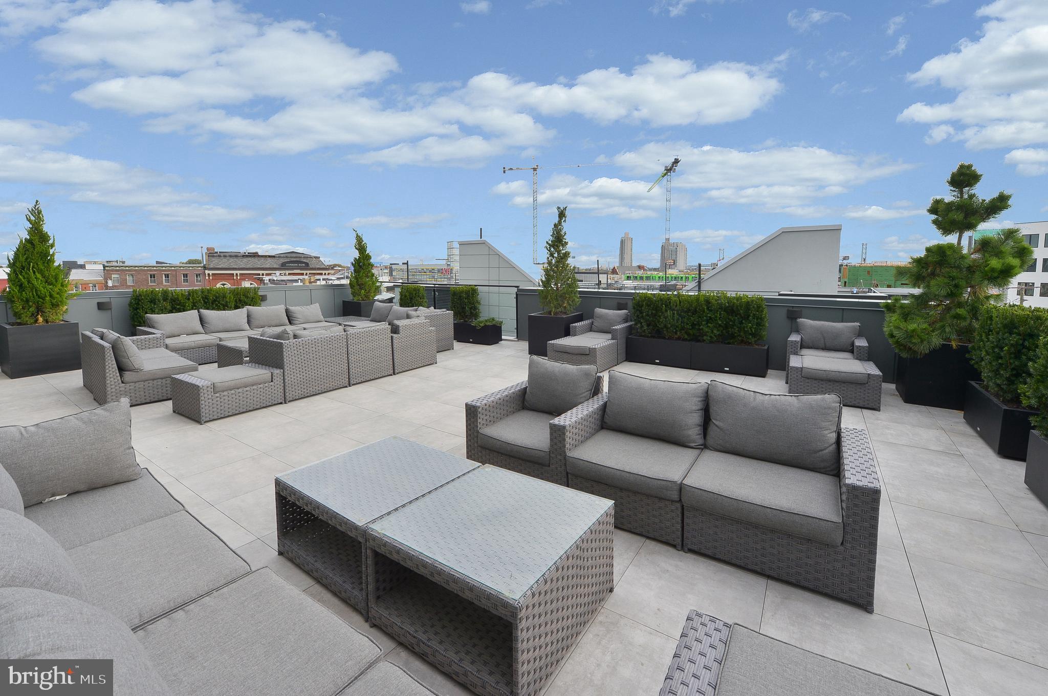 236 West Thompson Street, Unit B501 Philadelphia, PA 19122 - Photo 23 of 48 a view of a roof deck with couches and potted plants