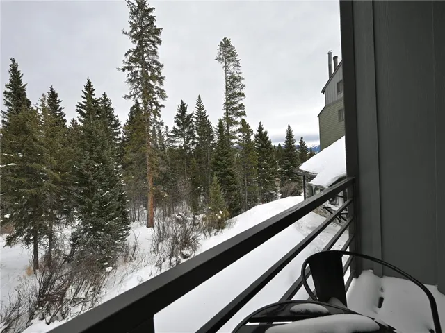 a view of a balcony with mountain view and trees