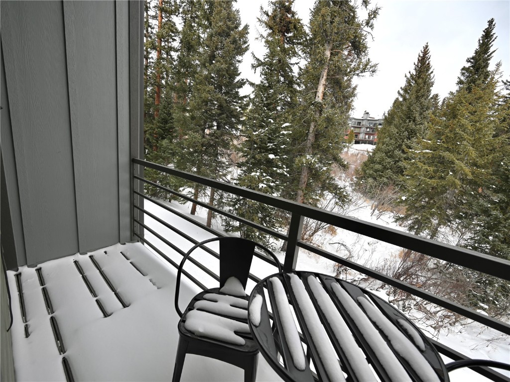 10000 Ryan Gulch Road, Unit 109 Silverthorne, CO 80498 - Photo 20 of 25 a view of balcony with wooden floor and fence