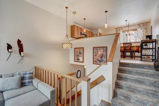 a view of a livingroom with furniture and staircase