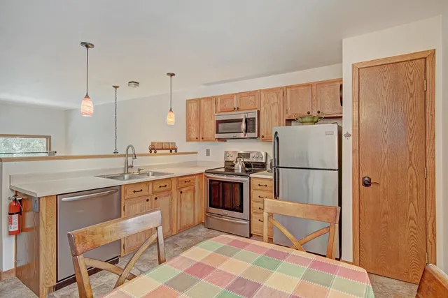 a kitchen with a refrigerator a sink and a stove