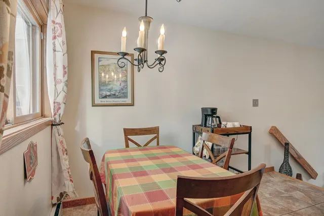 a view of a dining room with furniture and chandelier
