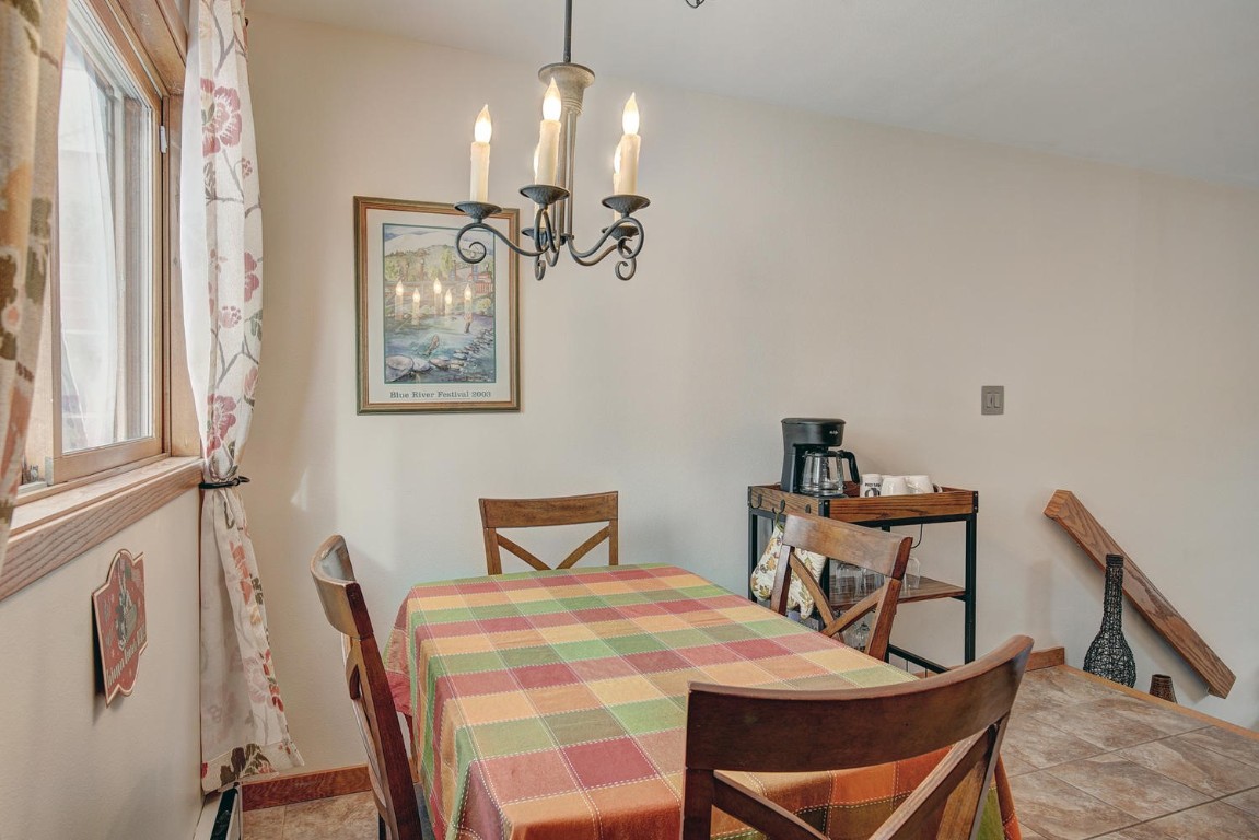 10000 Ryan Gulch Road, Unit 109 Silverthorne, CO 80498 - Photo 10 of 25 a view of a dining room with furniture and chandelier