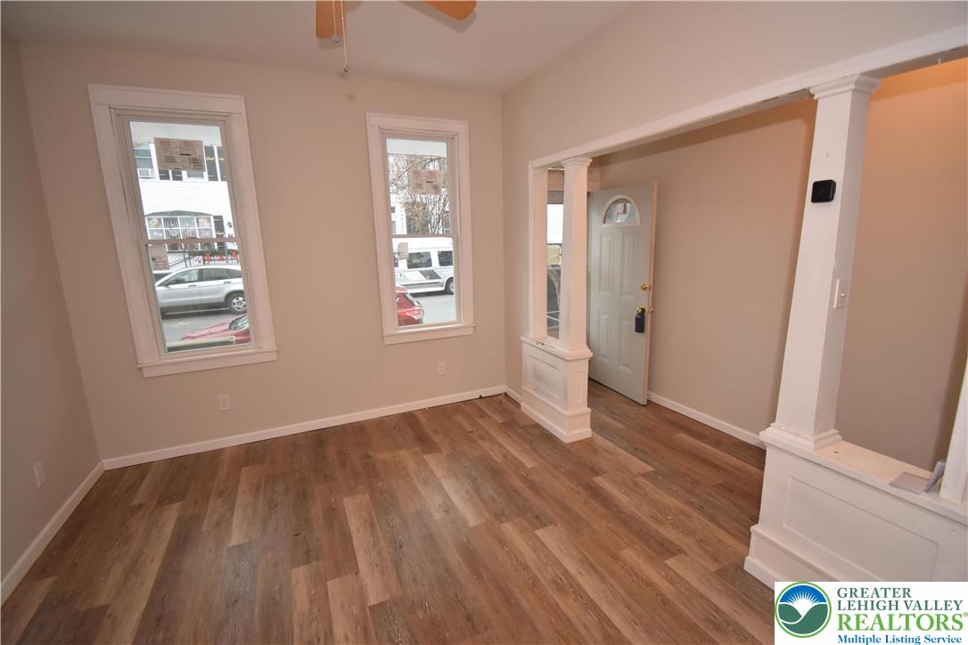 1105 Lehigh Street Easton, PA 18042 - Photo 2 of 9 a view of an empty room with wooden floor and a window