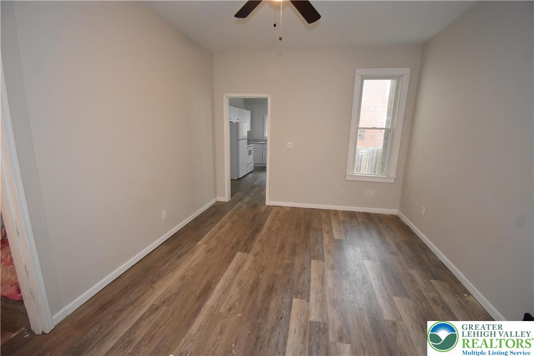 1105 Lehigh Street Easton, PA 18042 - Photo 3 of 9 a view of an empty room with wooden floor and windows
