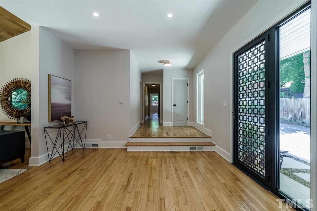 2005 Banbury Road Raleigh, NC 27608 - Photo 6 of 30 Open, light filled, an ideal flow for entertaining. The accordion-door package entirely opens to a large deck. Note the statement sloped ceiling. The divider separately a Formal Dining Room.