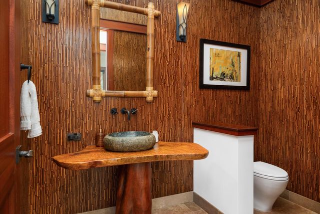 a bathroom with a sink a toilet and mirror
